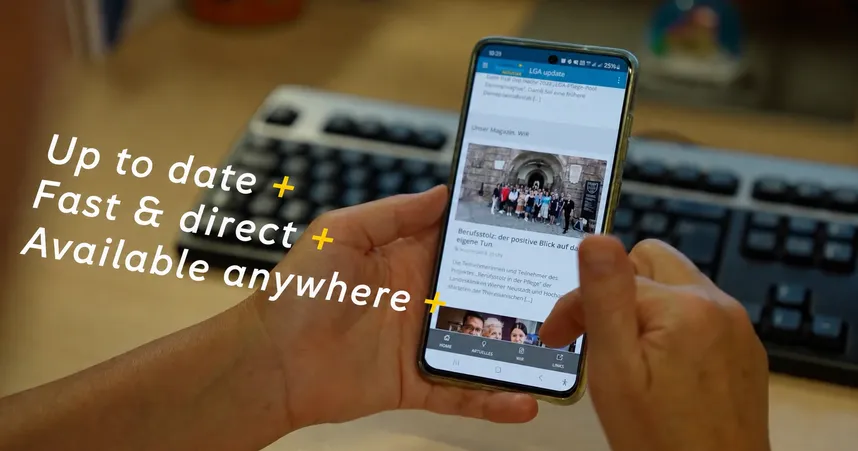 Hand holding a smartphone displaying a Staffbase employee app news feed, with overlay text "Up to date, fast & direct, available anywhere