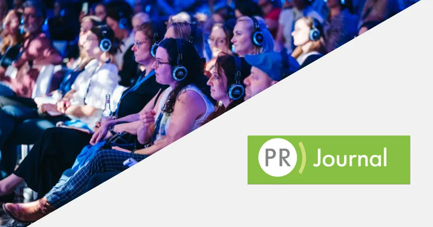 VOICES conference attendees sitting in the auditorium with headphones