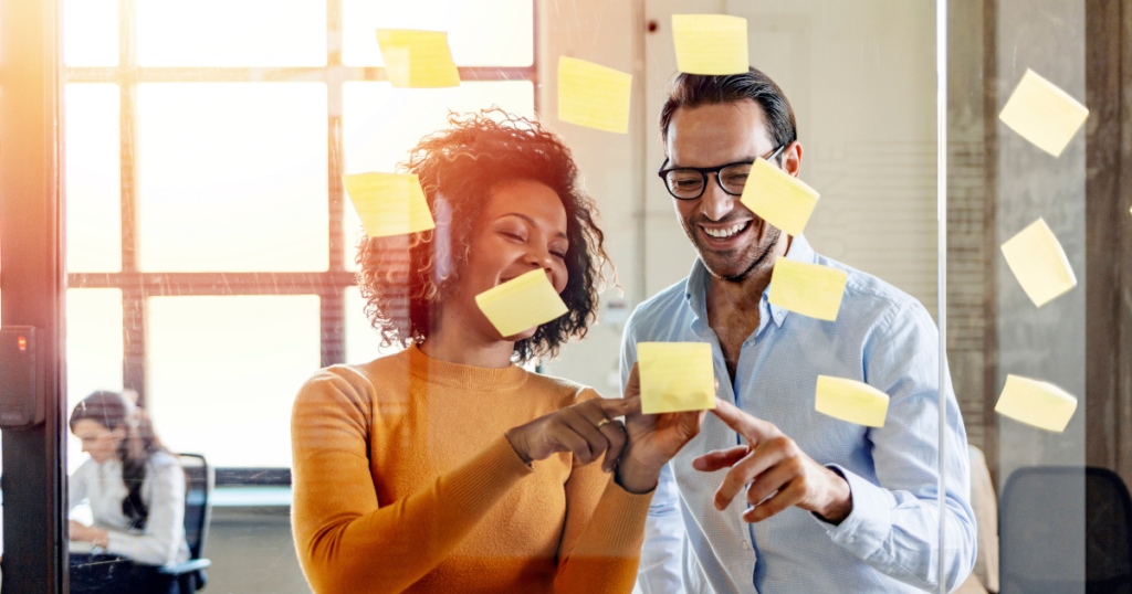 woman and man examining notes that contain company values examples