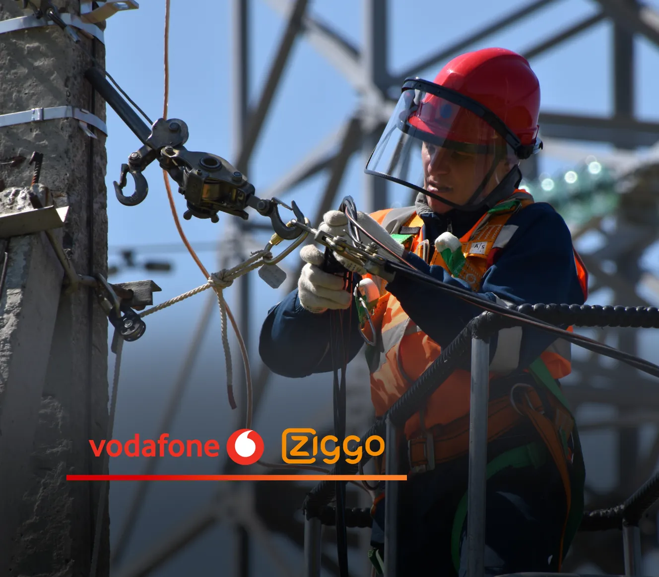 Telecom field worker in a red hard hat, face shield, and high-vis harness adjusts cables on a utility pole, with Vodafone and Ziggo logos overlaid
