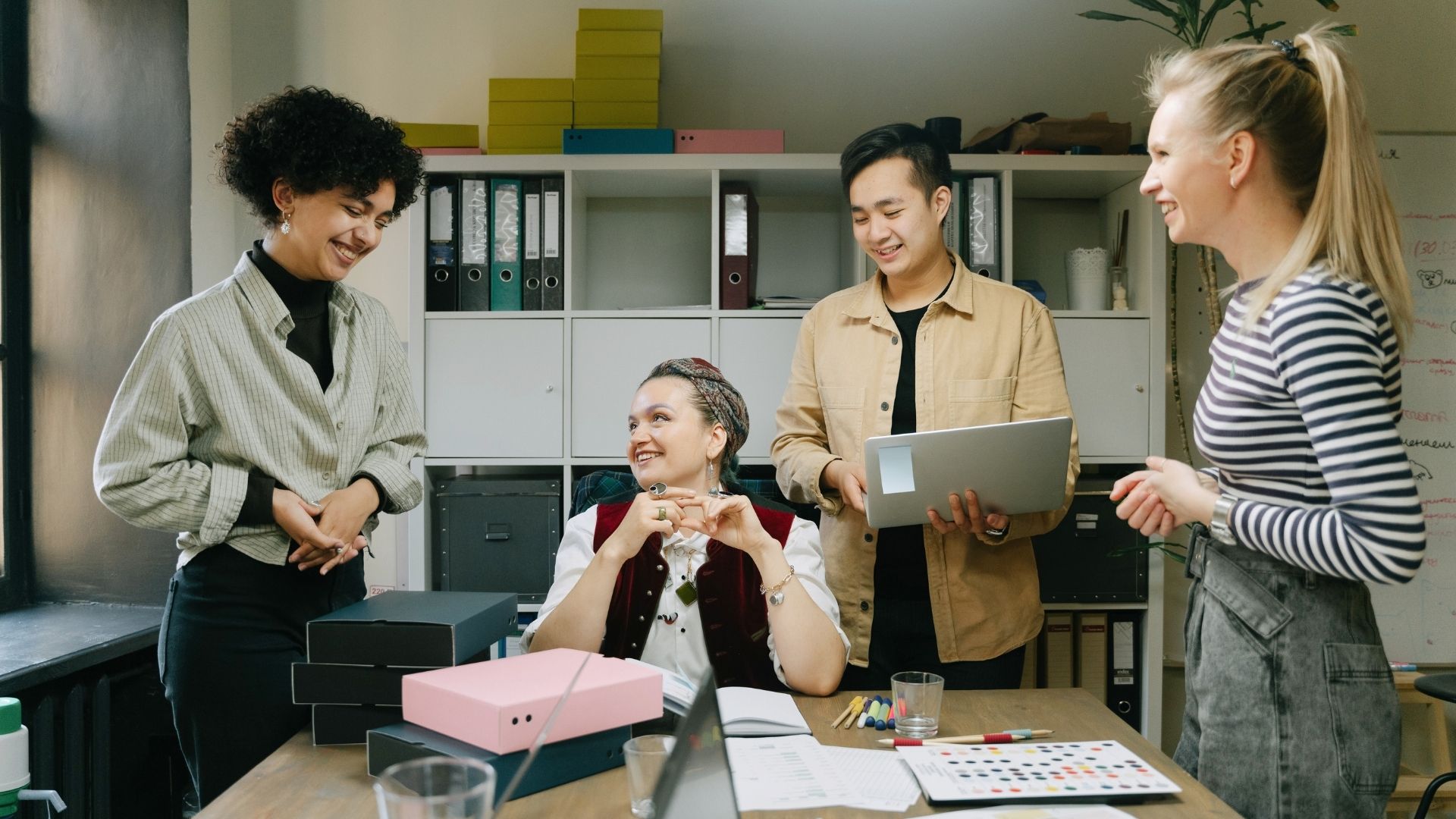 coworkers smiling with open computers