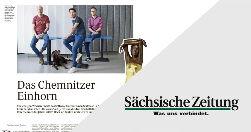 Three men sitting on a bench with a dog, featured in a newspaper layout titled "Das Chemnitzer Einhorn," alongside the "Sächsische Zeitung" logo.
