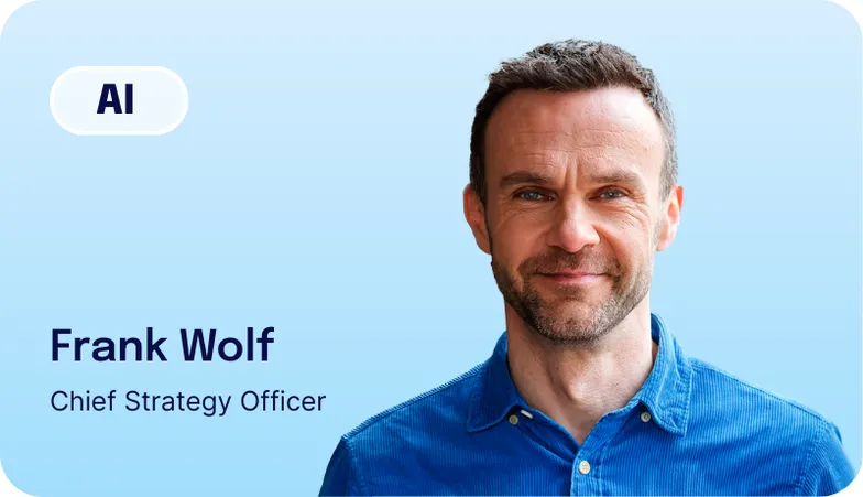 Frank Wolf in a blue shirt smiling, with text reading "AI", Frank Wolf, Chief Strategy Officer."