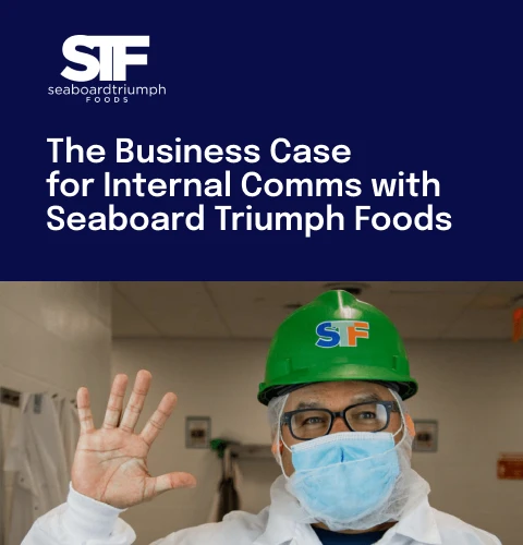 Worker in a green hard hat and mask waves in a food processing facility. Text reads: "The Business Case for Internal Comms with Seaboard Triumph Foods."