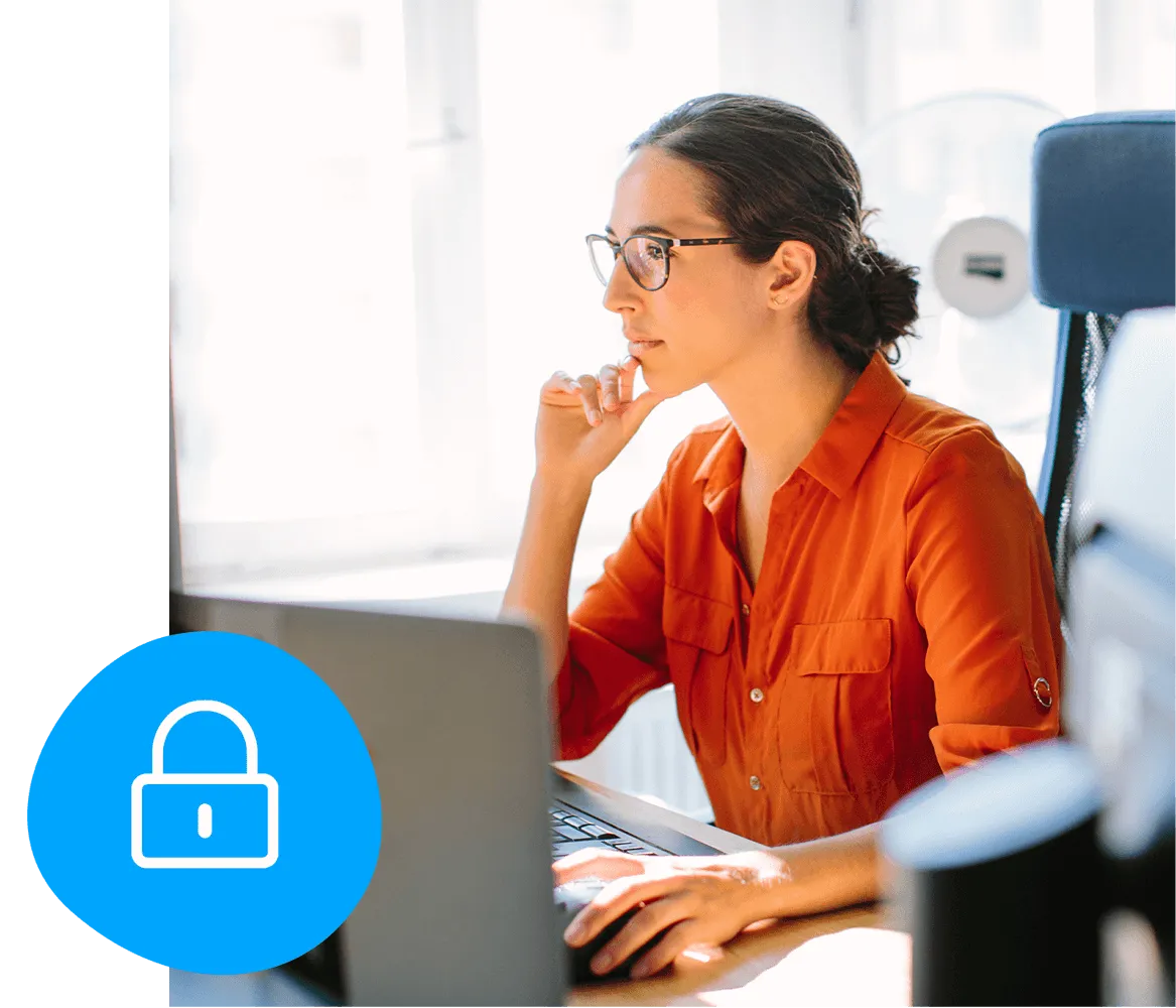 Woman in an orange shirt working on a laptop at a desk, with a blue padlock icon in the foreground, symbolizing security.