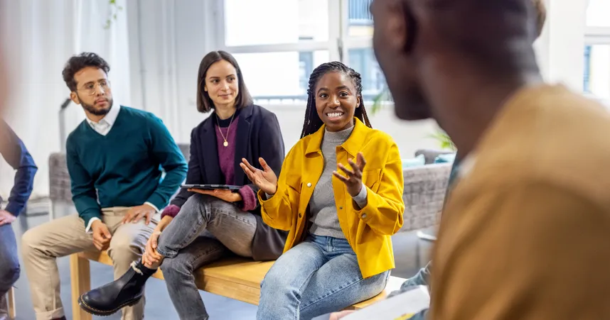 coworkers smiling and laughing with oppen hands