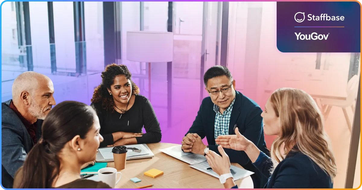 image of five coworkers at a table seemingly working and talking