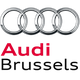 Audi logo with four interlocking silver rings above the text "Vorsprung durch Technik" in red and black.